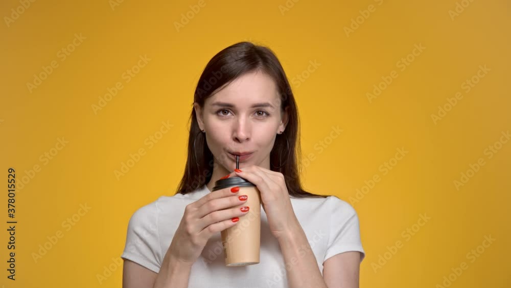 Young woman holds a cup of coffee take away. Young woman holds a cup of coffee take away.