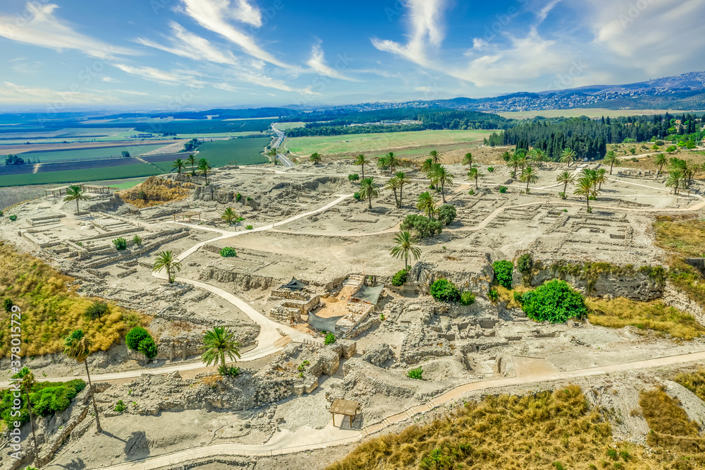 Aerial panorama of the ruins of the ancient city of Tel Megiddo, archaeological park, site of the biblical Armageddon in Israel with cloudy sky