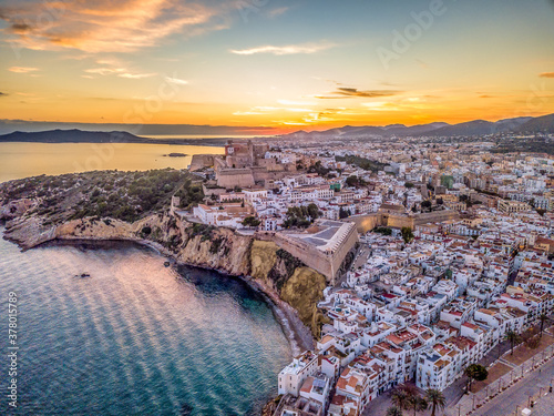Aerial view of stunning sunset over Ibiza (Evissa) during a winter evening with view of the medieval fortress and the old town photo