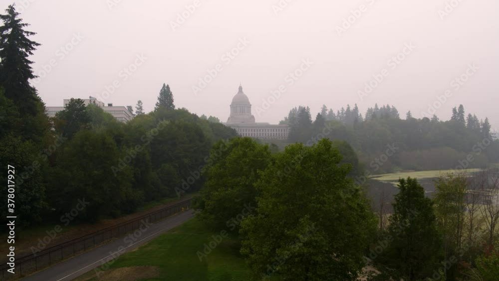 Drone pull of Wahington state capitol building and surrounding buildings, lake and park in Olympia with smoke from nearby fires Drone pull of Wahington state capitol building and surrounding buildings, lake and park in Olympia with smoke from nearby fires