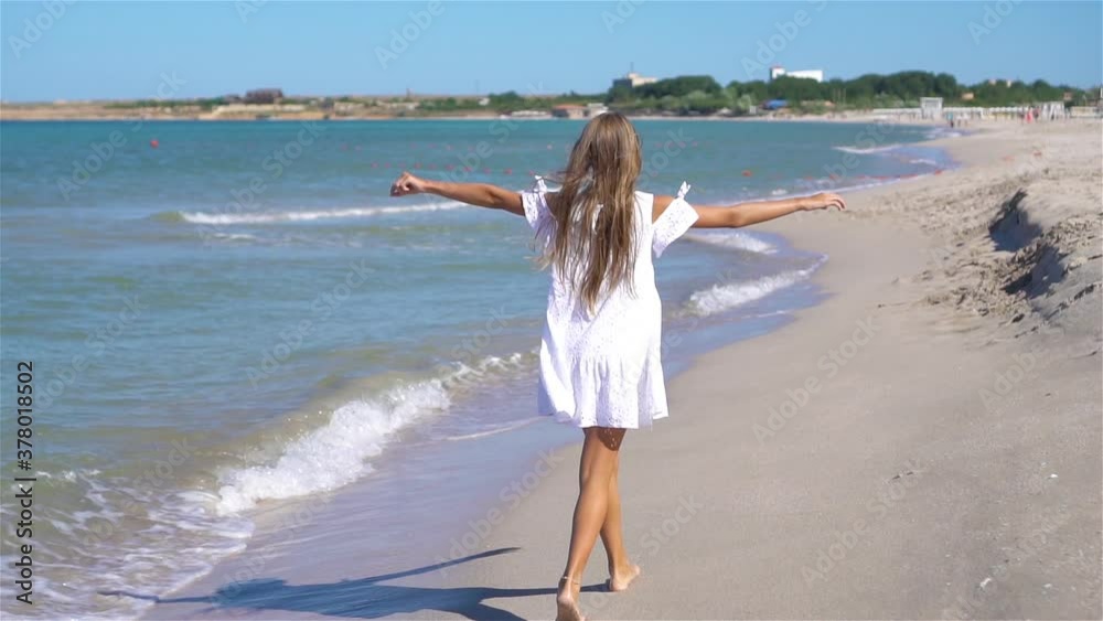 Adorable little girl at beach during summer vacation Adorable little girl at beach during summer vacation