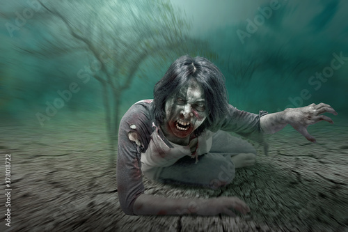 Scary zombie with blood and wound on his body crawling