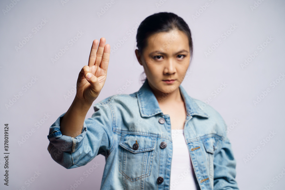 Asian woman showing three finger isolated over white background. Asian woman showing three finger isolated over white background.