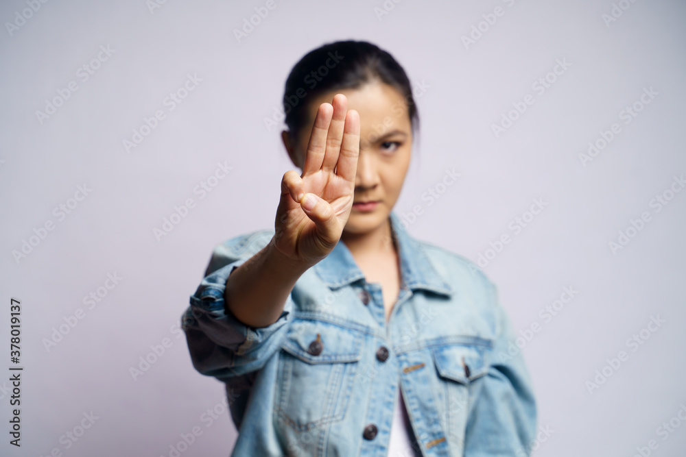Asian woman showing three finger isolated over white background. Asian woman showing three finger isolated over white background.