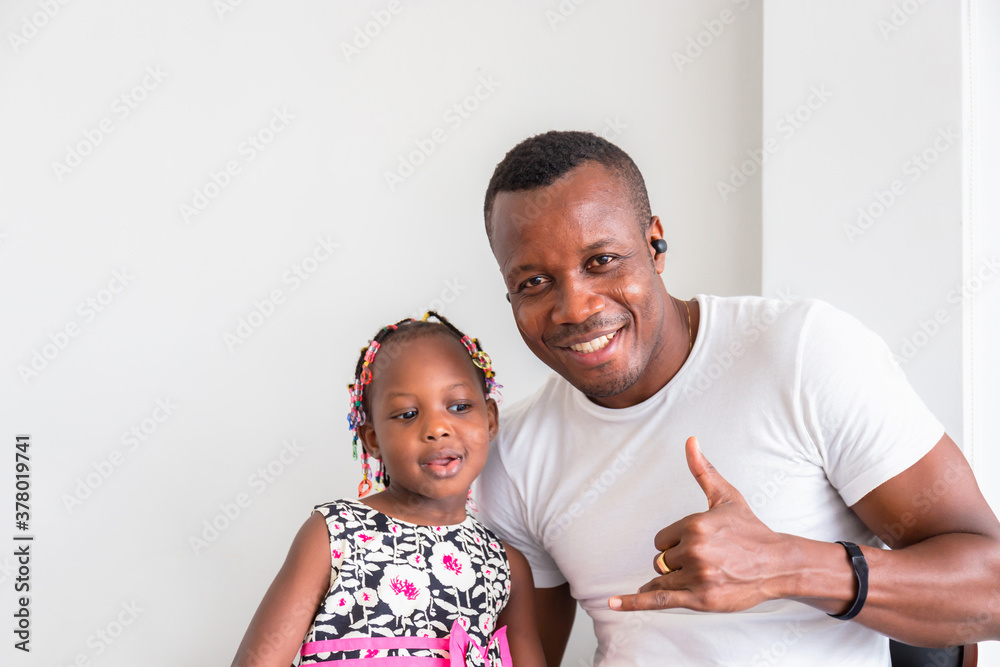 Cheerful african american father and daughter playing in living room, Happiness family concepts