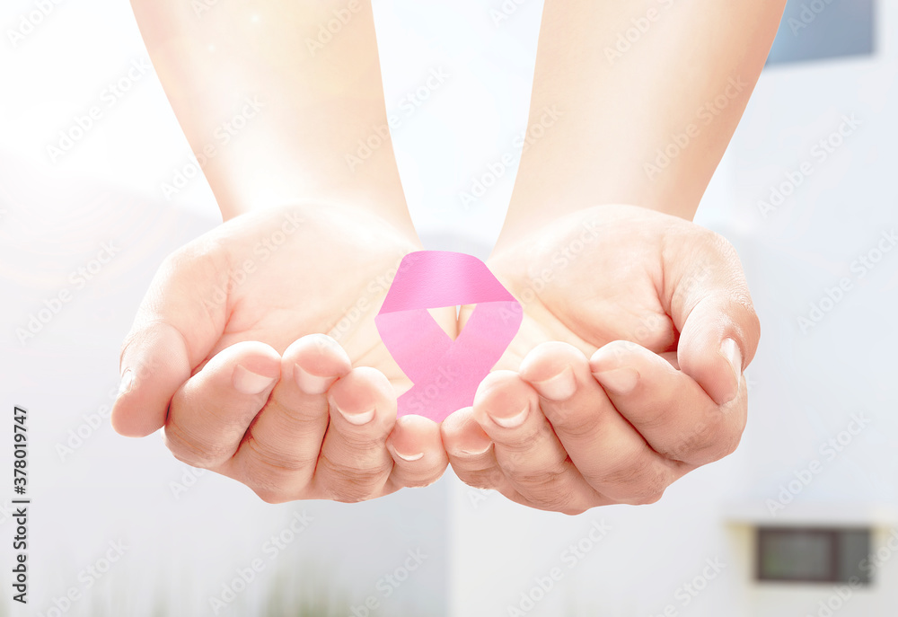Human hands showing pink awareness ribbon Human hands showing pink awareness ribbon