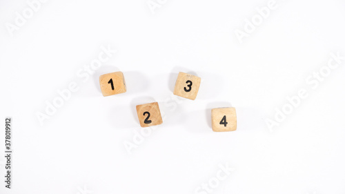 Top view of four wooden dice on white background