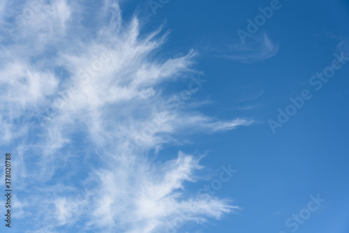 Fresh air  bright blue sky with wispy white clouds  as a nature background 