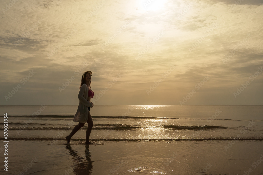 cheerful woman in bikini walking on sea beach cheerful woman in bikini walking on sea beach