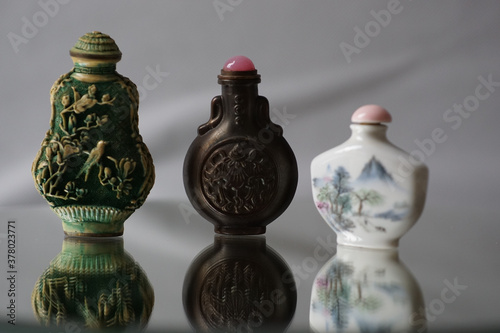 Fotografija Closeup of ornamented iron and porcelain snuff bottles