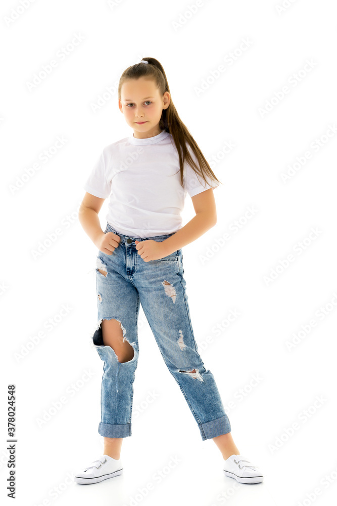 Beautiful teen girl in jeans with holes. Photos | Adobe Stock