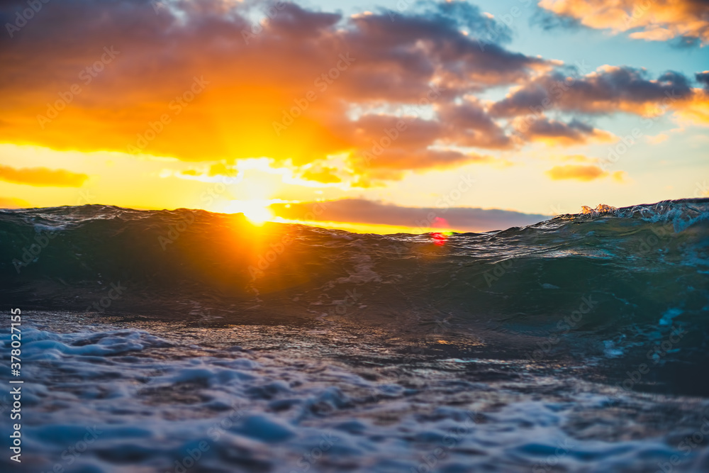 Naklejka premium Sea wave close up, low angle view, sunrsie shot