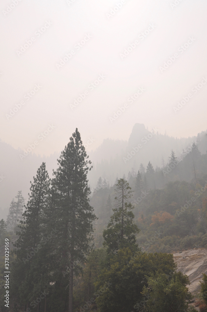 Very hazy and smokey view of mountains and trees from Yosemite Valley, during wildfire season