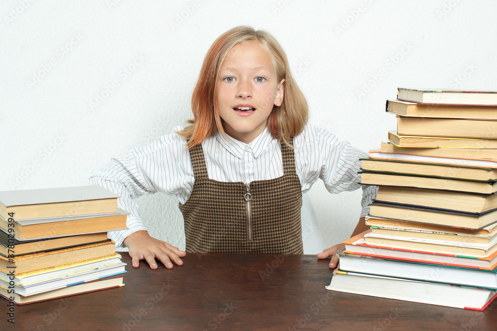 A teenage girl stands among the books and looks emotionally at the camera. A teenage girl stands among the books and looks emotionally at the camera.