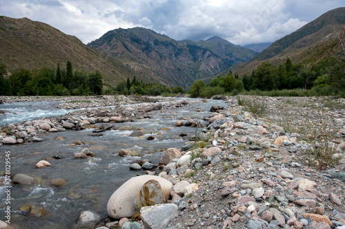 River with mountain torrent and many rocks. Wild nature landscape. Adventure tourism. Tough nature concept. Usek river gorge in Kazakhstan. Nature of Kazakhstan, tourism concept. photo