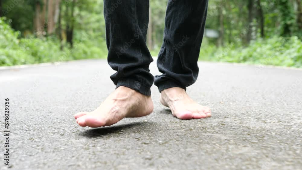 Asian man hiking walk in rainforest jungle wearing protective mask In public Asian man hiking walk in rainforest jungle wearing protective mask In public