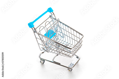 Sale banner. Food shopping basket for retail market. Empty trolley cart for supermarket isolated on white background. Sale, discount, shopaholism concept. Consumer society trend.