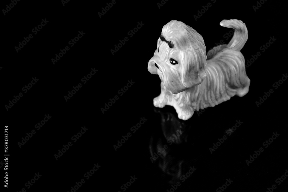 Fototapeta premium plastic toy dog on a reflective surface abstract background