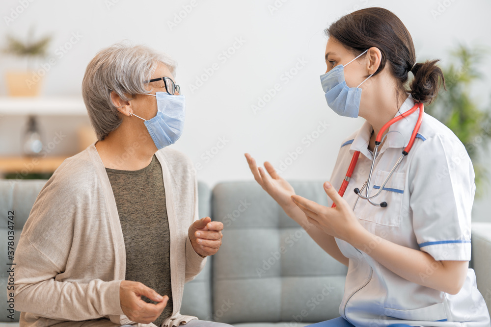 Doctor and senior woman wearing facemasks Doctor and senior woman wearing facemasks