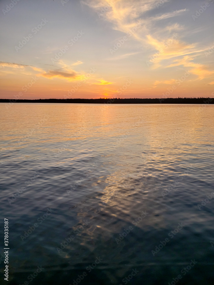 Sunset over calm water on Child's Lake in Duck Mountain Provincial Park, Manitoba, Canada Sunset over calm water on Child's Lake in Duck Mountain Provincial Park, Manitoba, Canada