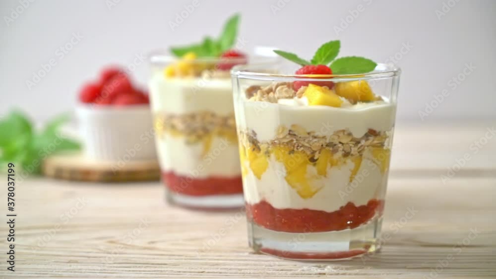 homemade fresh mango and fresh raspberry with yogurt and granola - healthy food style homemade fresh mango and fresh raspberry with yogurt and granola - healthy food style