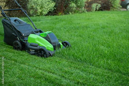 Lawn mower on a green lawn. photo