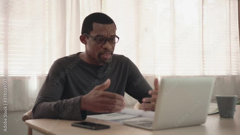 African American man making video call meeting on laptop at home African American man making video call meeting on laptop at home