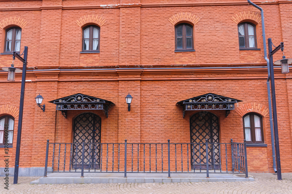 Fototapeta premium Red brick house in the square