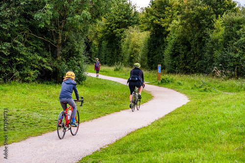 Fototapeta Naklejka Na Ścianę i Meble -  Cyclists Cycling on Bicycles The Greenway Cycle and Walking Track Nr. Stratford upon Avon Warwickshire English Midlands England UK.
