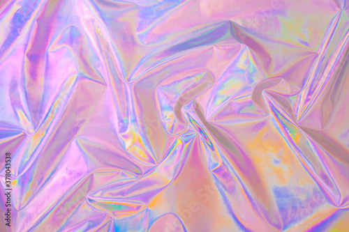 Abstract Modern pastel colored pink holographic background in 80s style. Crumpled iridescent foil textile real texture. Synthwave. Vaporwave style. Retrowave, retro futurism, webpunk