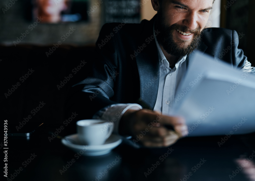 business man sitting at a table in a cafe documents work official coffee cup business man sitting at a table in a cafe documents work official coffee cup
