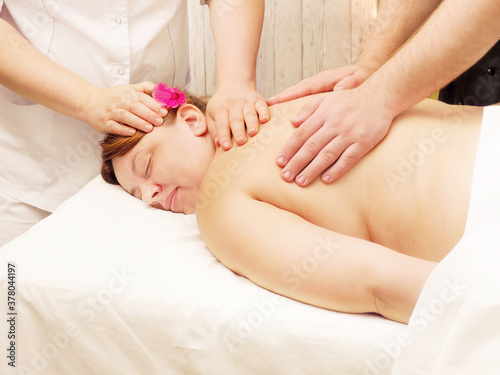 Bodypositive woman with closed eyes in spa salon getting massage. Health  beauty  resort and relaxation concept
