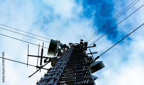 Ground and up look of a big cellular communications tower providing mobile phone services in both 4G and 5G. 