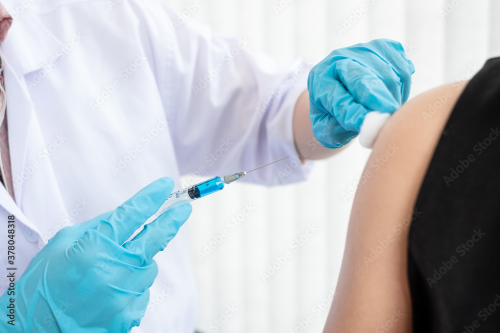Male doctors vaccinated with syringes to prevent epidemics at hospitals, health care, and medical concepts Male doctors vaccinated with syringes to prevent epidemics at hospitals, health care, and medical concepts