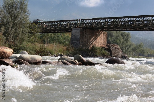 A river flowing under a bridge in Kashmir, India.