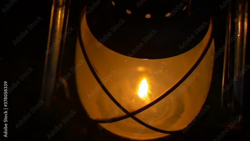 View of a burning wick vinatge lantern in night.