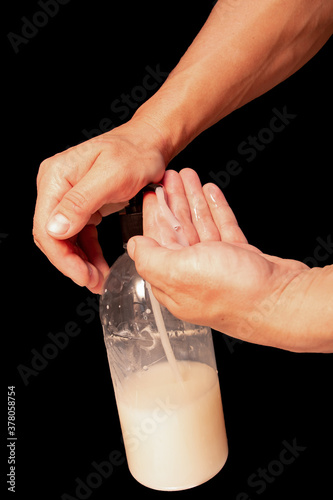 washing hands with soap on black background