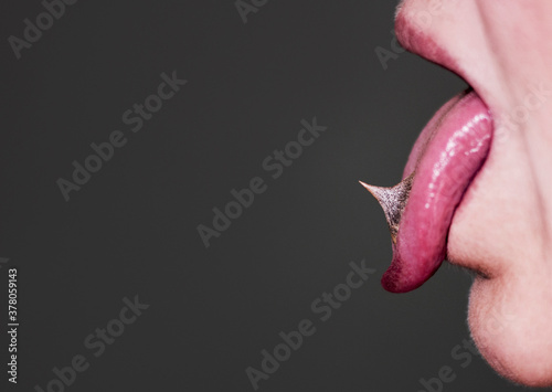 Tongue out, spikes on a tongue, close up