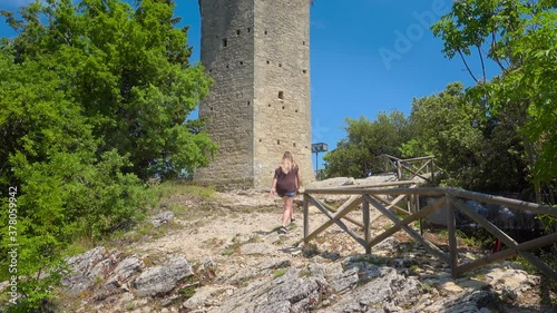 Girl looks at San Marino, Montale, the third tower of three peaks which overlooks the city. The tower is located on the highest of Monte Titano's summits.