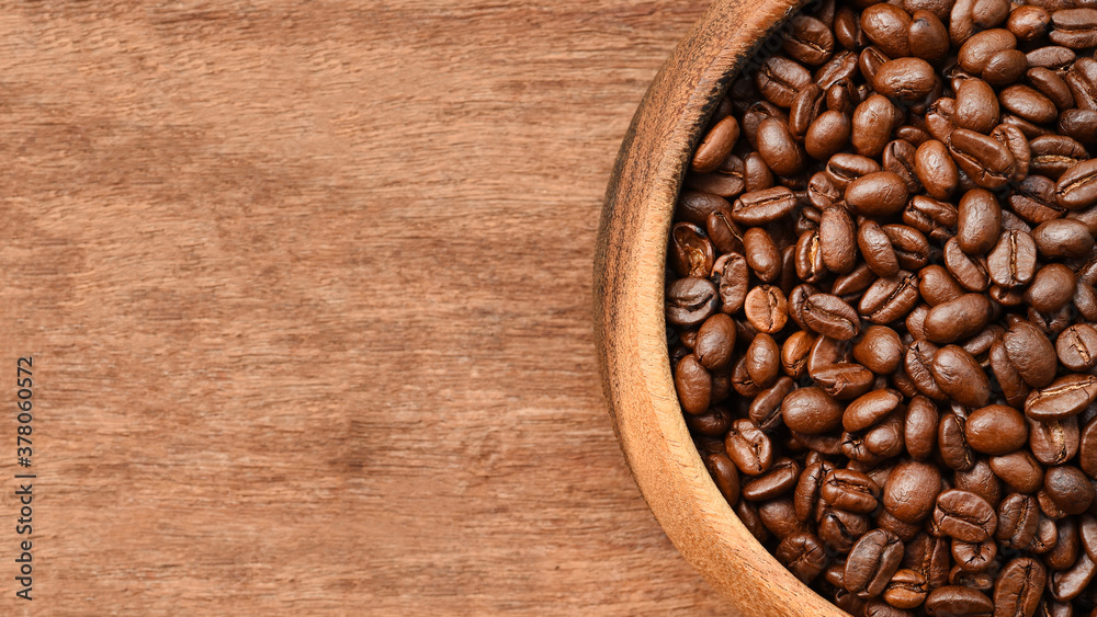 Fototapeta premium Close up of coffee beans in wooden bowl for background