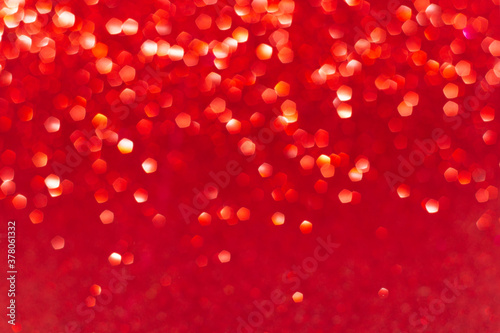 Festive new year background in red with bright bokeh lights .Gradient of lights from top to bottom. Space for notes and captions.