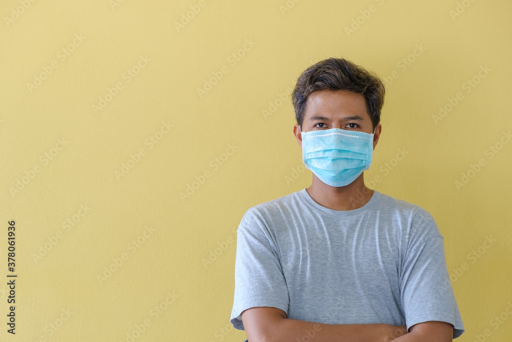 Workers wearing masks for safety in the face of the COVID epidemic stand in front of a yellow scene. Workers wearing masks for safety in the face of the COVID epidemic stand in front of a yellow scene.