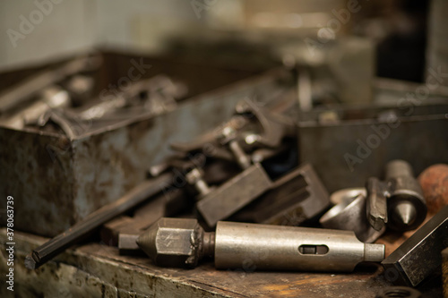 metal parts and tools in the factory, worker's table, locksmith tools in the workshop