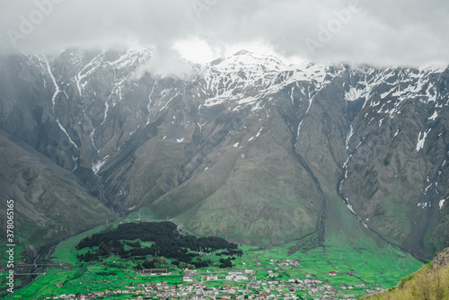 mountains of georgia gudaugi mountain peaks ridges in the snow in the green