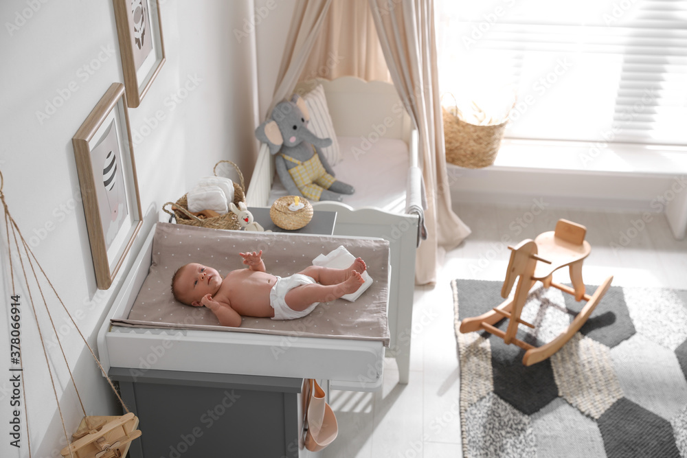 © New Africa - Cute little baby on changing table in room © New Africa - Cute little baby on changing table in room