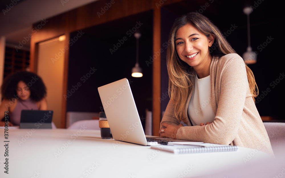 Portrait Of Businesswoman With Laptop At Socially Distanced Meeting In Office During Health Pandemic Portrait Of Businesswoman With Laptop At Socially Distanced Meeting In Office During Health Pandemic