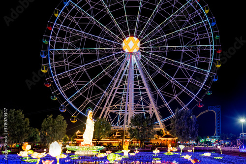 Ferris wheel in the amusement park at night