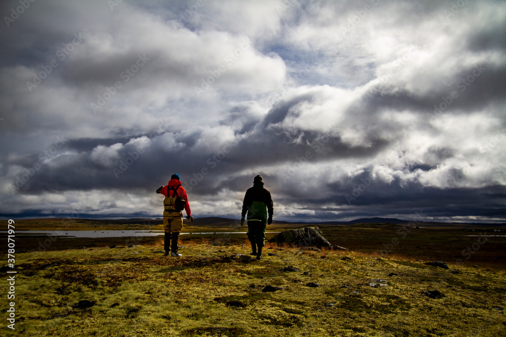 Two guys walking on the high plains of Norway