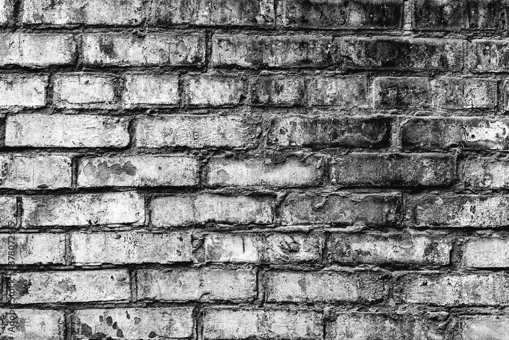 Texture of a brick wall with cracks and scratches which can be used as a background Texture of a brick wall with cracks and scratches which can be used as a background