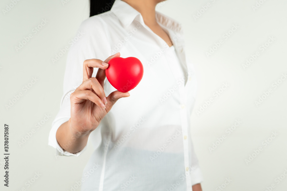 World heart day concept of young woman hand holding red heart